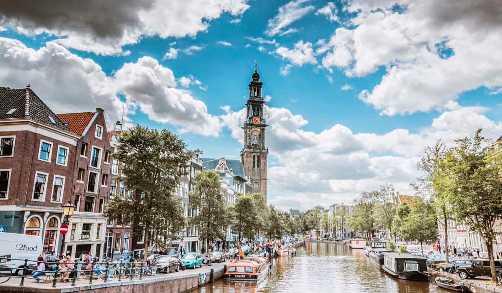 A canal in Jordaan, Amsterdam lined with houseboats