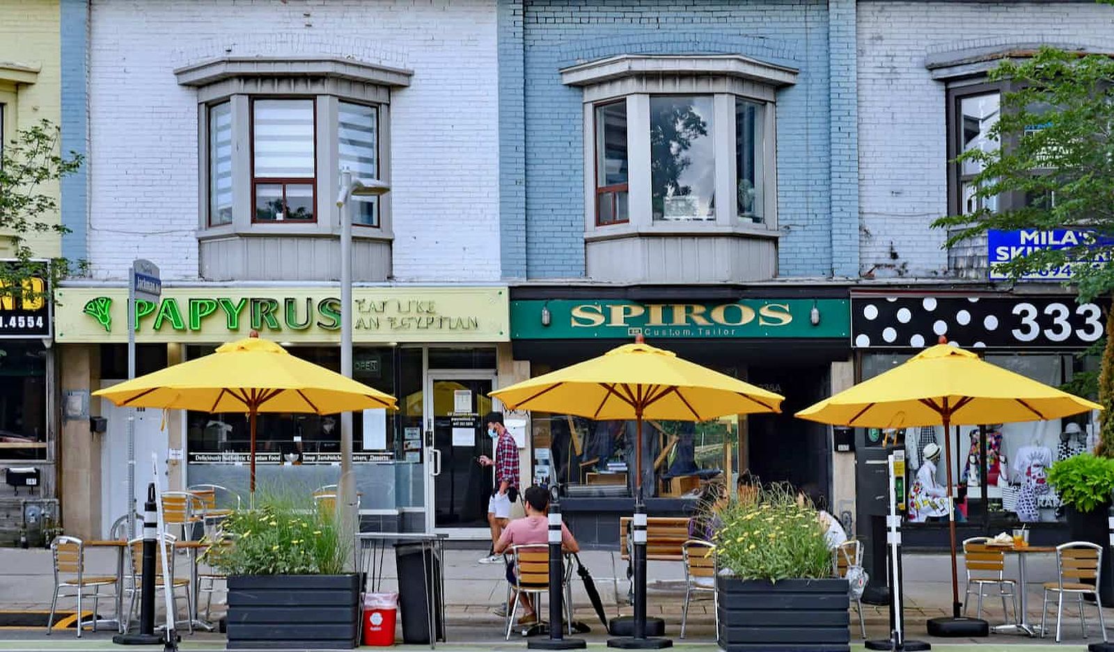 People relaxing at a restaurant outside in the Danforth area of Toronto