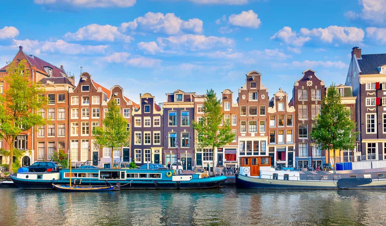 Row of colorful townhomes in Amsterdam along a historic canal